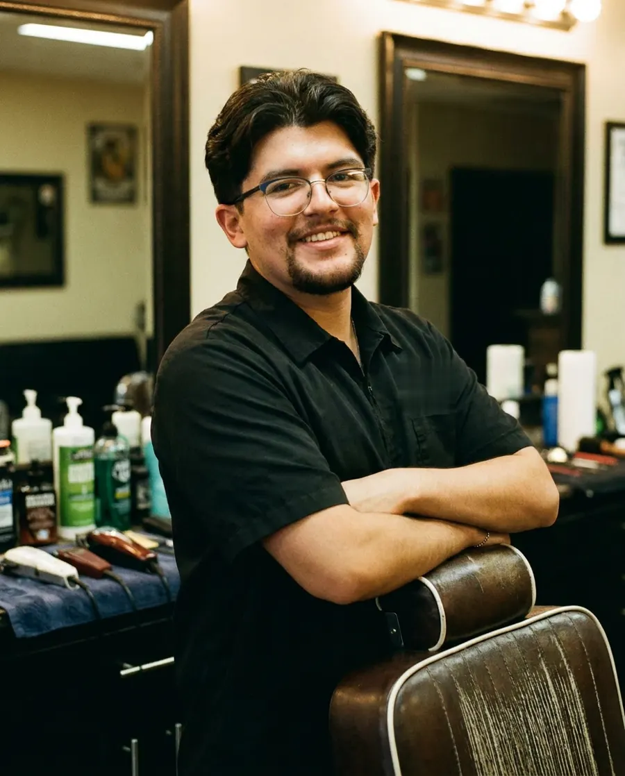 Sammy at his chair at Q’s Barbershop
